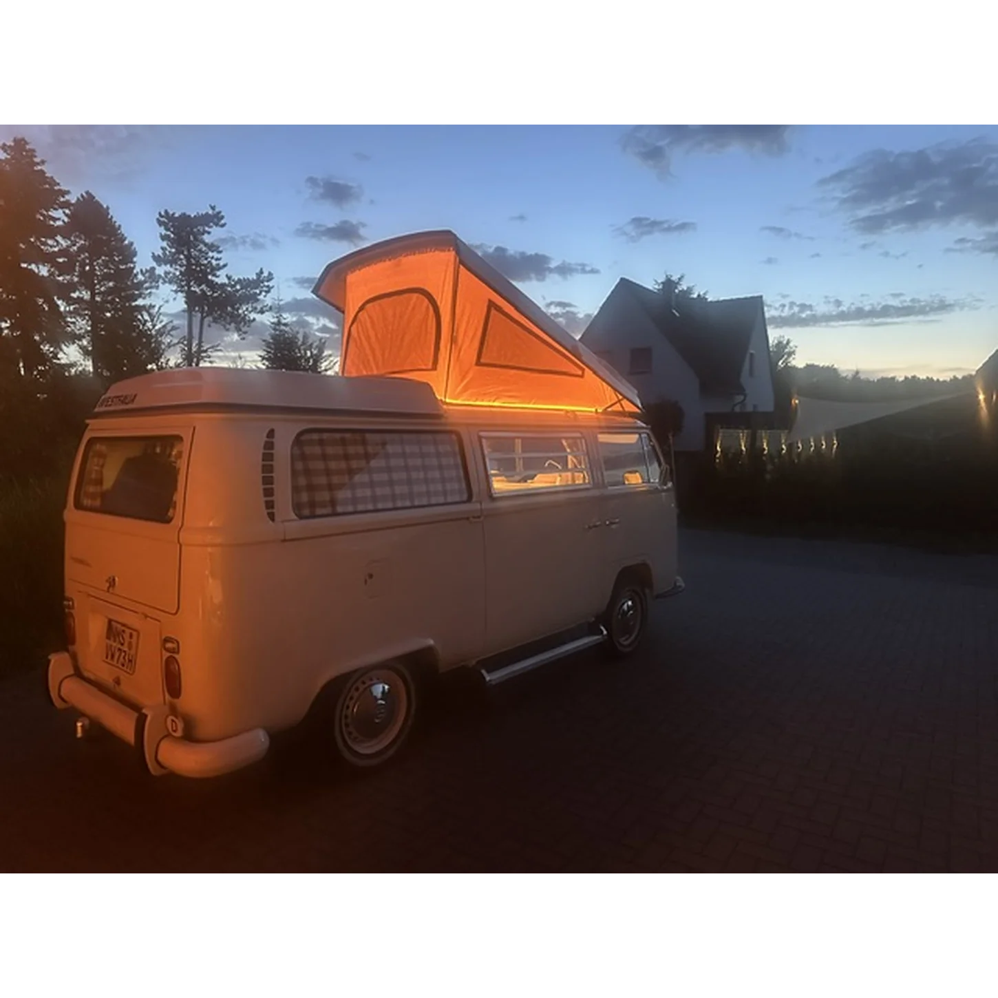 VW T2 Campingbus mit Aufstelldach in Abendstimmung, ausgestattet mit Autositzfellen aus Lammfell